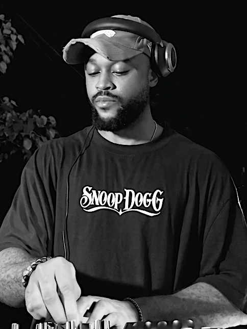 DJ KUR8 wearing headphones and mixing music
